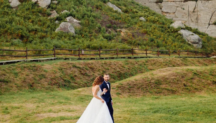 Couple walks on aisle at outdoor wedding